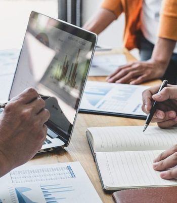 a man sitting at a table using a laptop